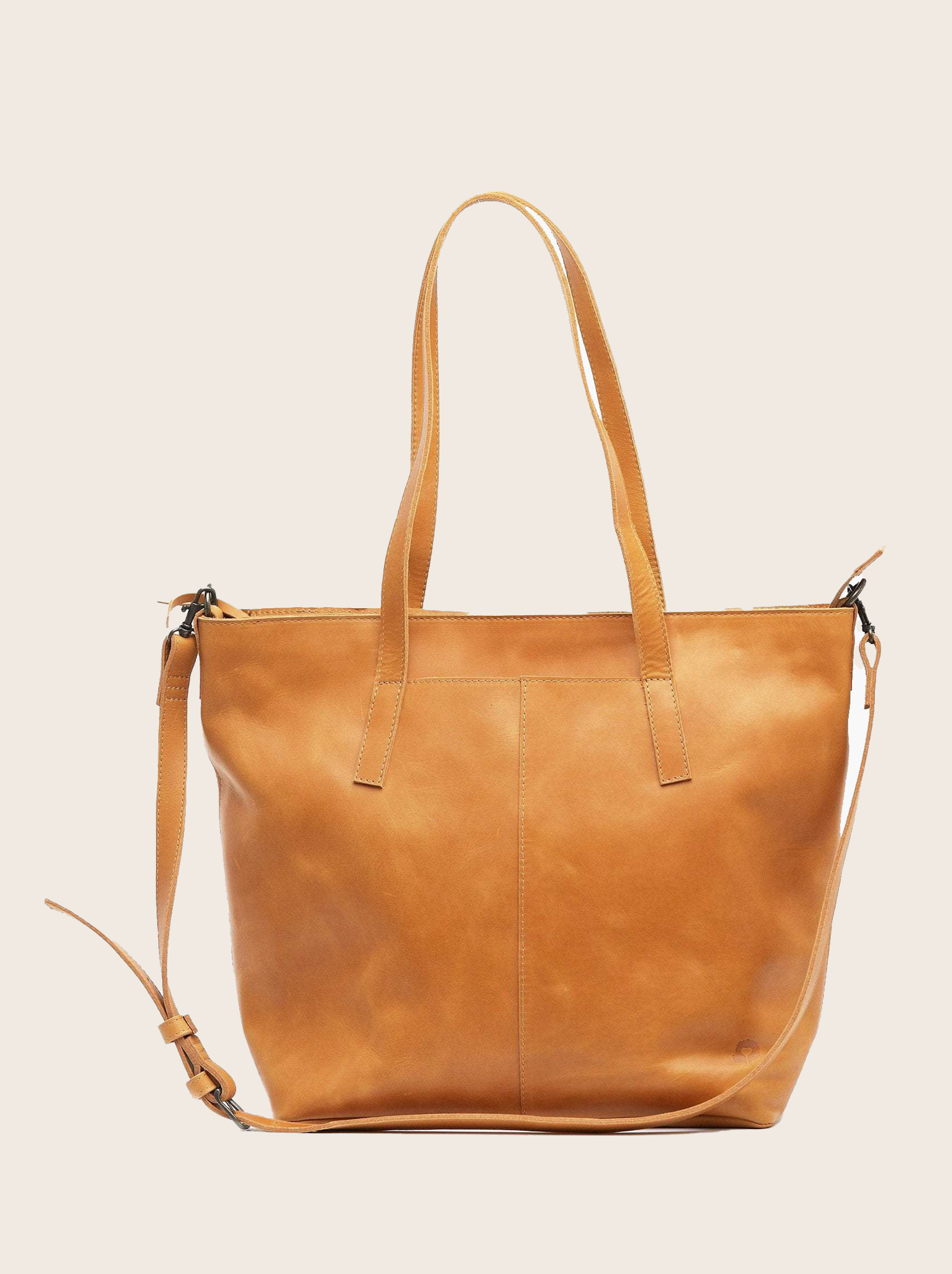A cognac orange leather utility tote bag with two handles/shoulder straps and crossbody strap displayed against a plain background. #Color_Cognac
