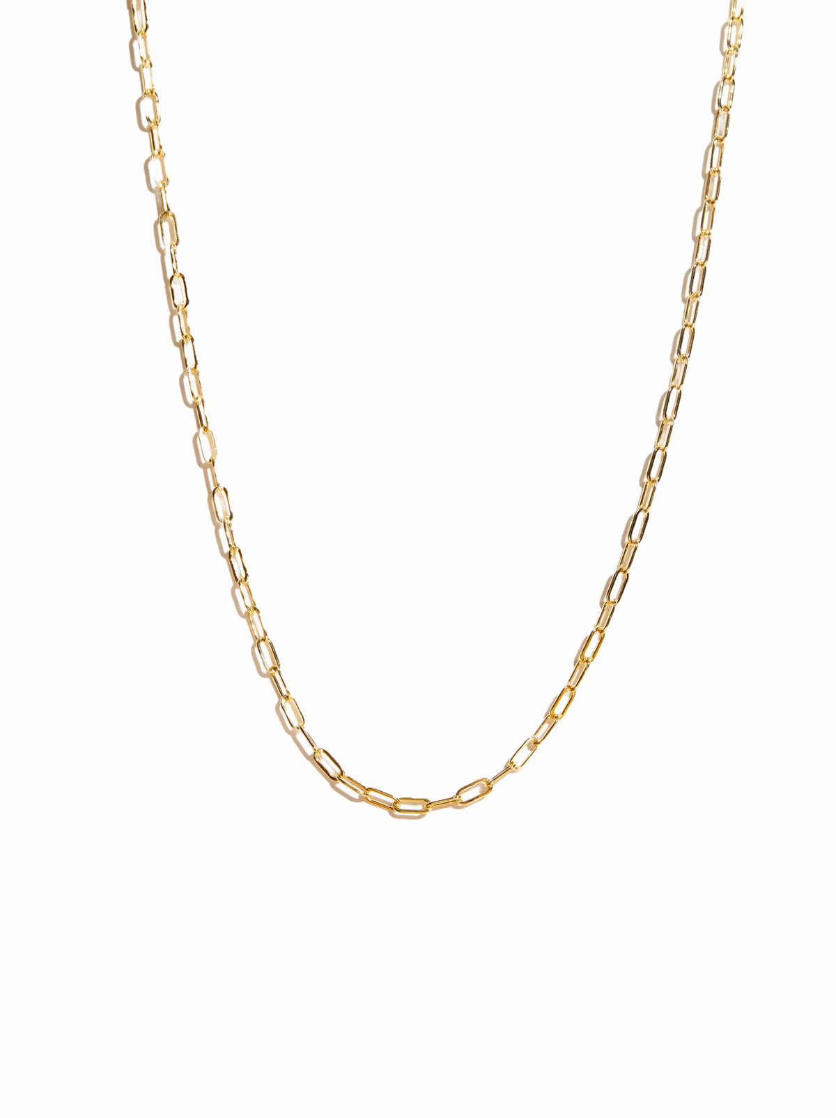 A gold paperclip chain necklace displayed against a solid white background.