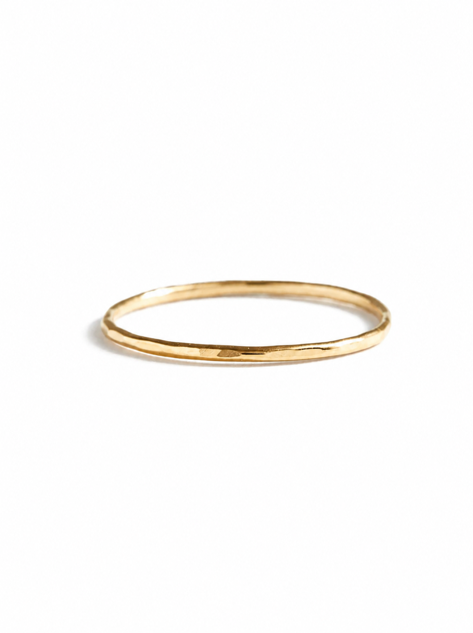 Gold hammered textured ring on a white background.