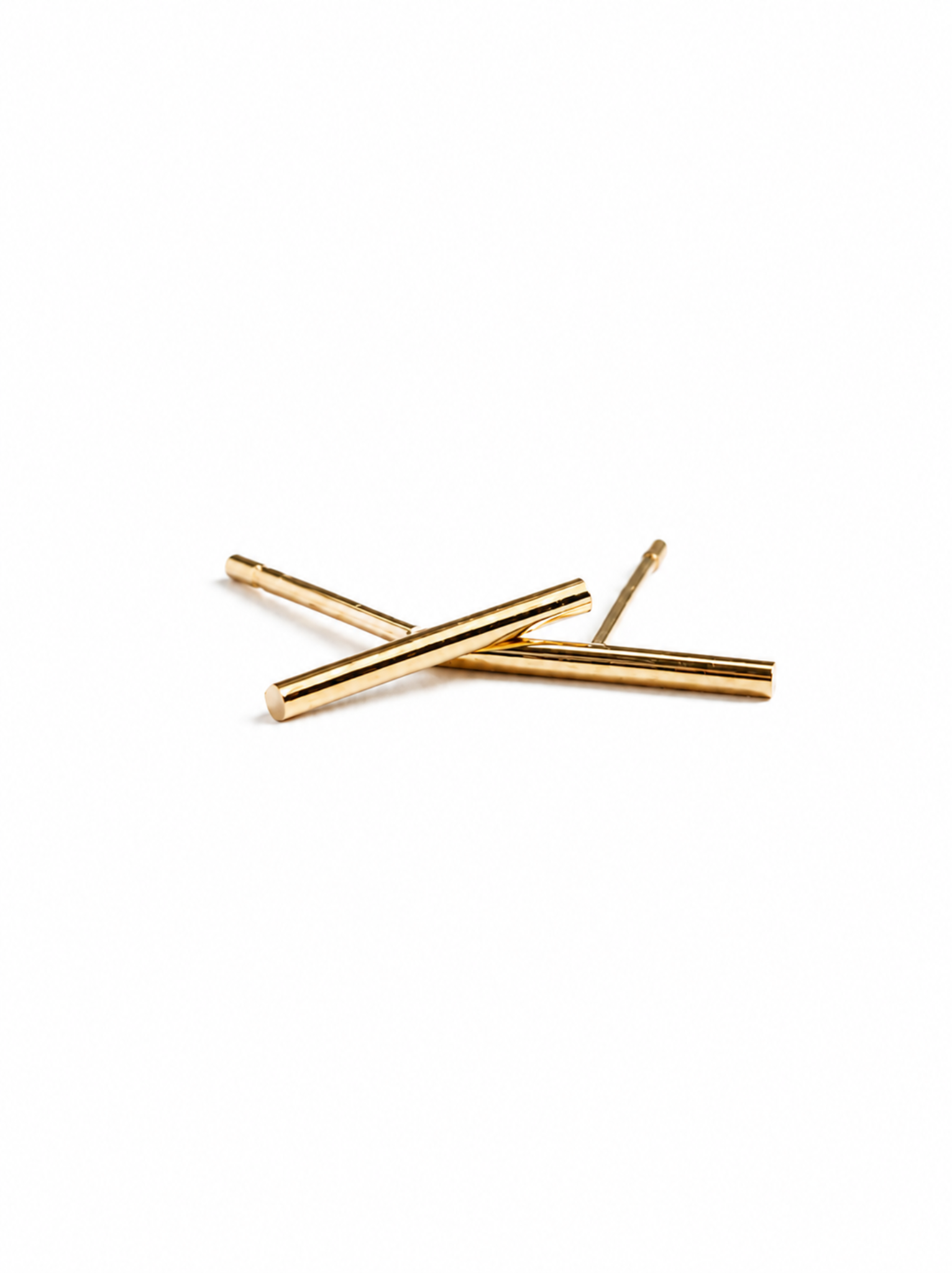 A pair of gold stick stud earrings on a white background. #Color_14k Gold-filled