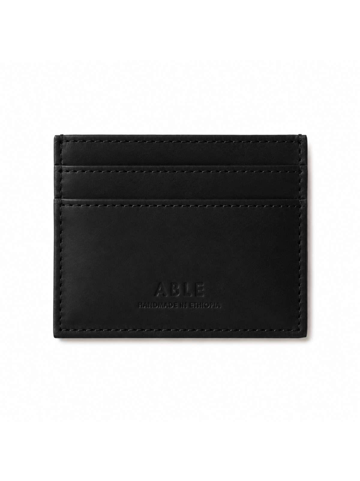 A black leather card holder wallet with visible stitching and debossed branding on a clean white background. #Color_Black