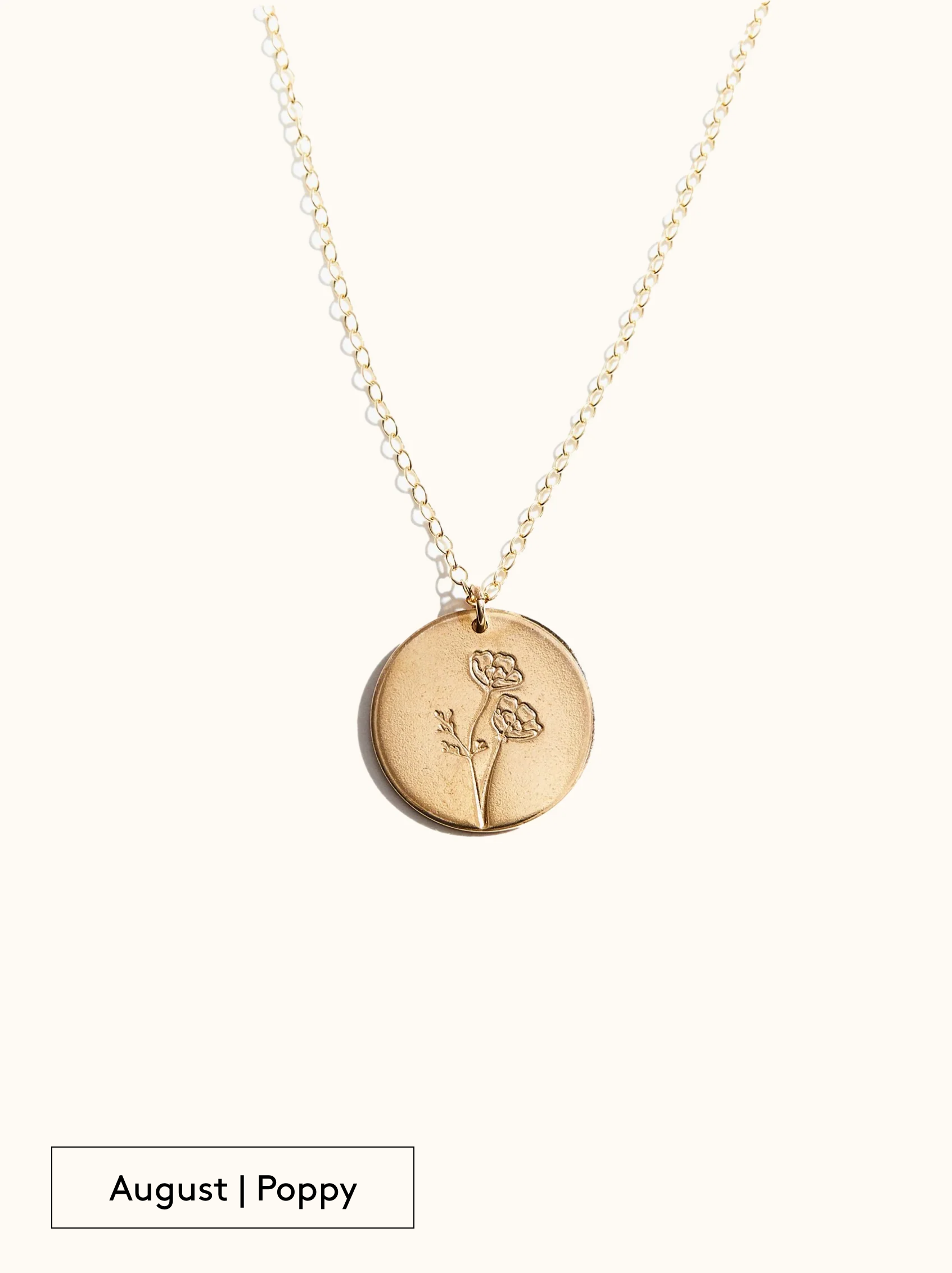 A gold-filled necklace with a round tag pendant featuring an engraved Poppy, noted as August's birth month flower, attached to a 24 inch chain on a neutral background.