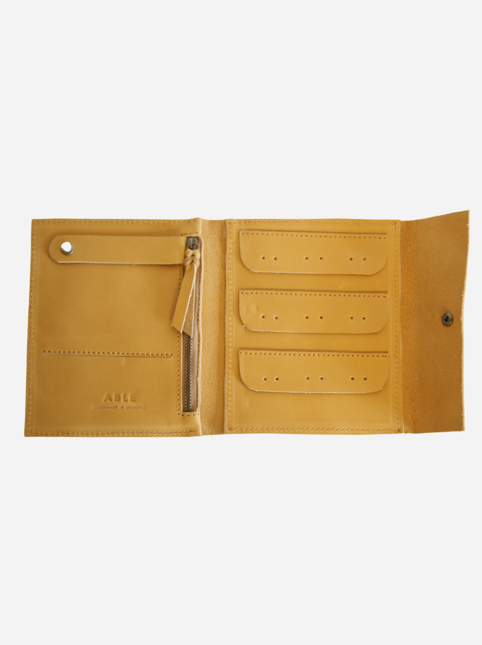 Interior of cognac jewelry case with zipper pocket, necklace snap tab and slit pocket, and 9 earring pair holes. #Color_Cognac