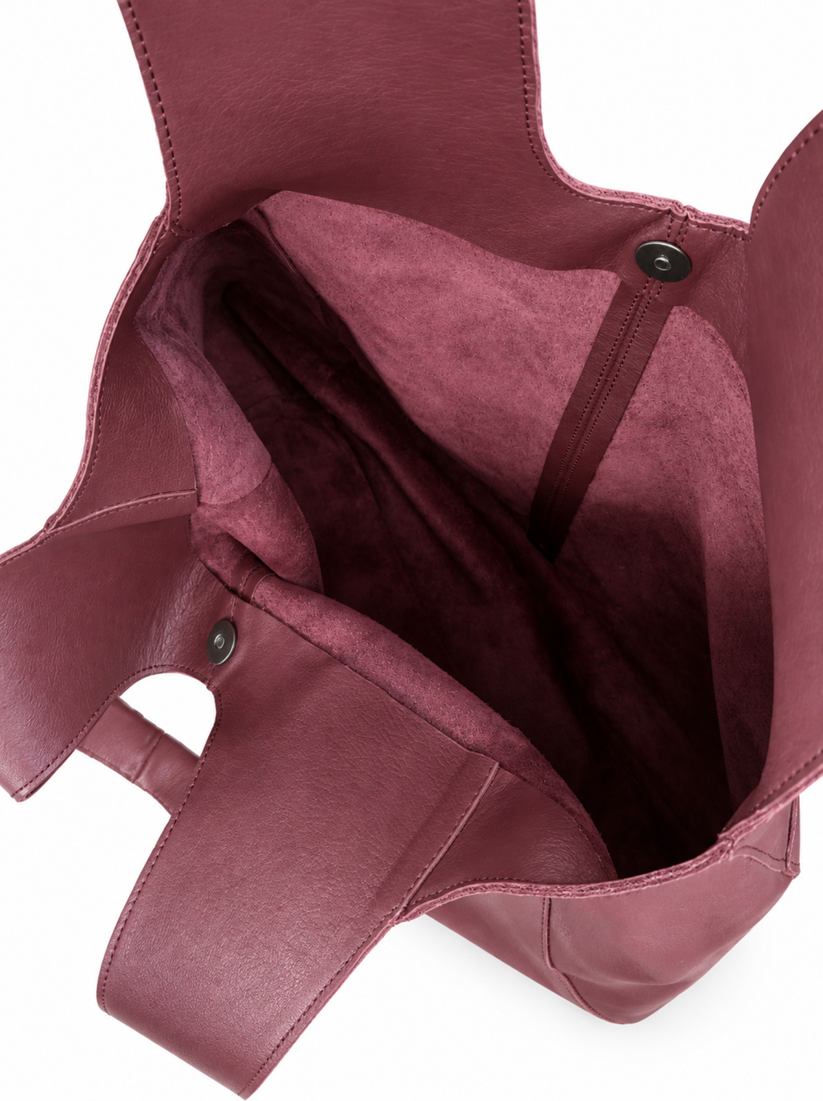 Close-up of the interior of a deep burgundy leather tote bag, showing the  snap-magnetic closure against a white background. #Color_Oxblood