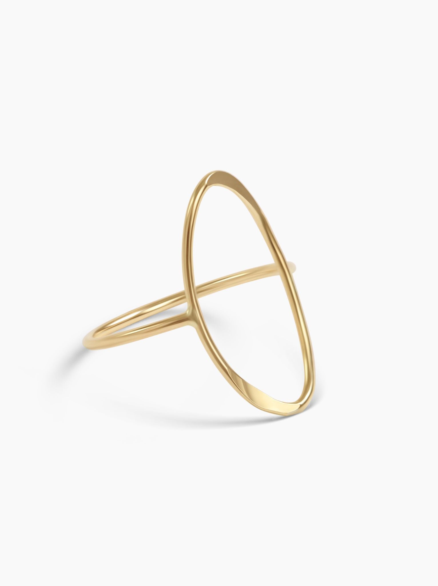 Angled view of gold oval ring on a white background.
