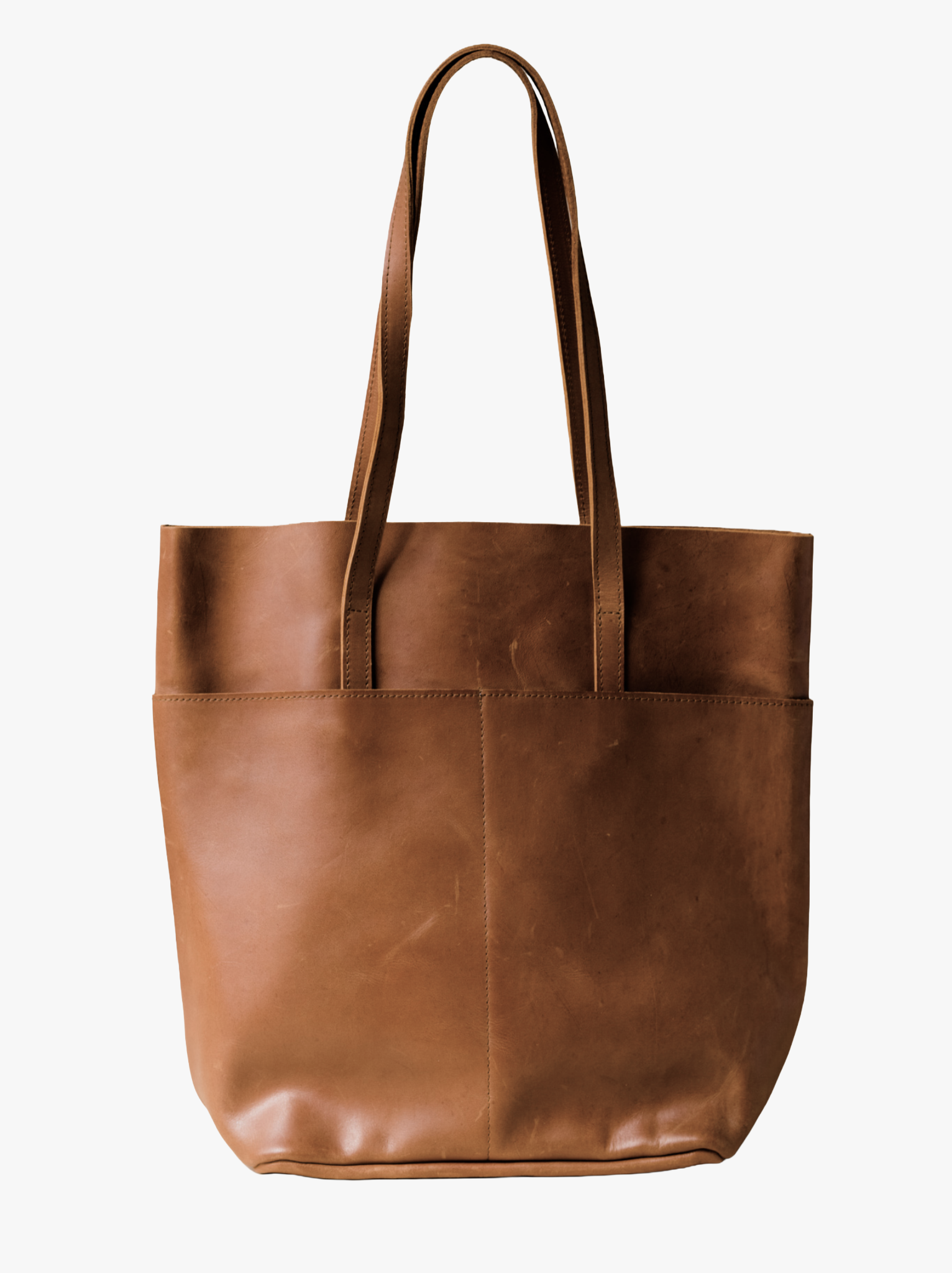 A brown leather tote bag with two shoulder straps, shown against a plain white background. #Color_Whiskey