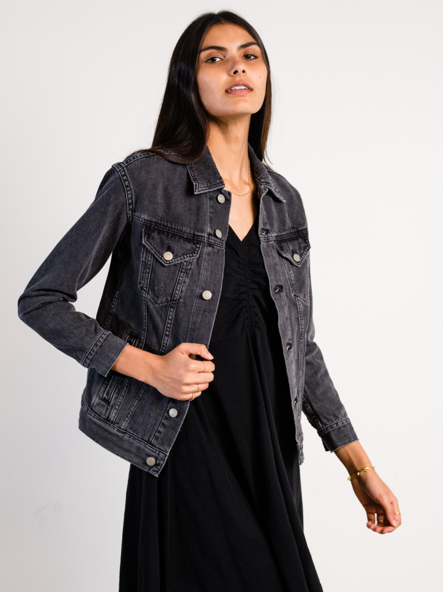 Woman wearing The Merly Jacket Washed Black over a black dress on a white background #Color_Washed Black