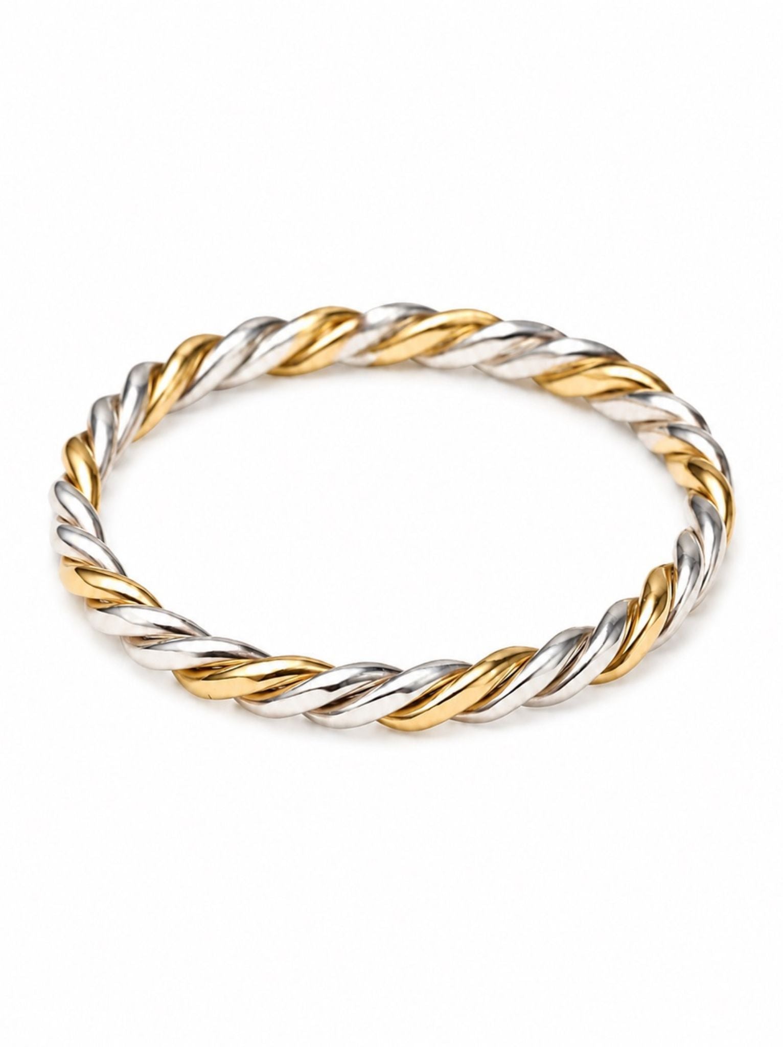 Two-tone gold and silver twisted ring on a white background.